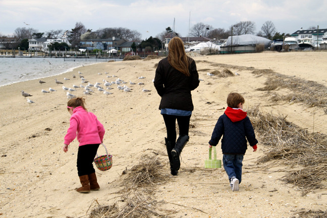 Laura Whitehouse, with her children Liam and Avery, searched the brush looking for stray Easter eggs.