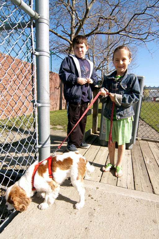 A young girl and her brother wisely use their pooches sense of smell to help them track down the Easter bunny at the John Street Complex in Bay Park, East Rockaway.
