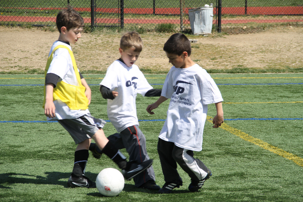 Michael Deprimo, left, Justin Rozzo and Tyler Lanci competed for control of the ball during a camp training session.