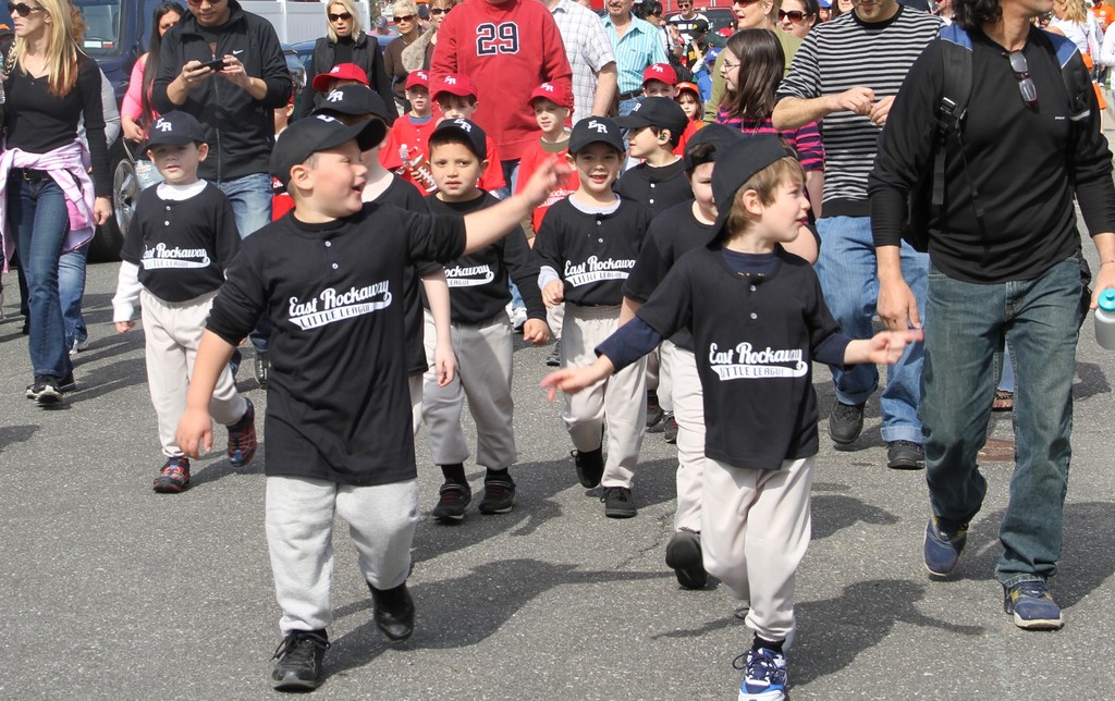 Little LEaguers waved to the crowd as they marched in the parade.