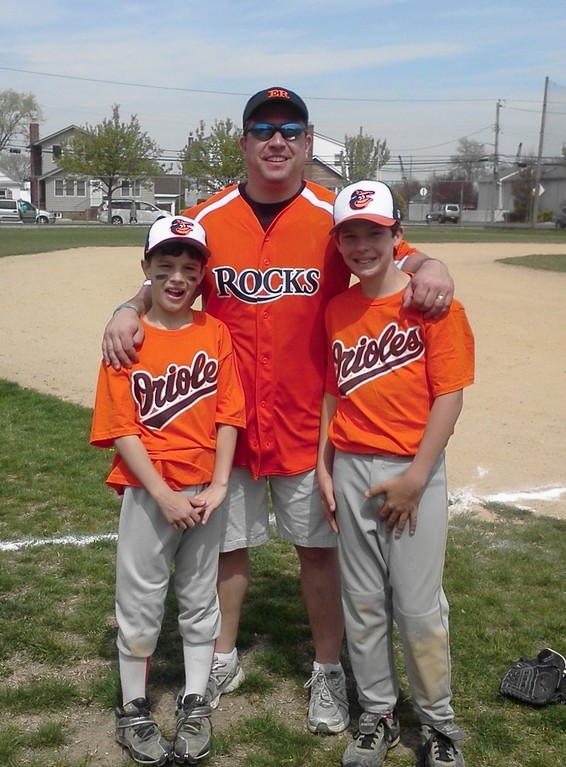 Vice President and Orioles Assistant Coach Tom La Barbera with his sons, Andrew, 11, left, and Matthew, 12 on opening day of the East Rockaway Little League at the John St Complex.