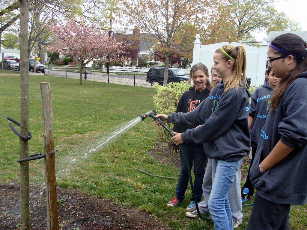 Members of the builders club added water to their newly-planted seeds.