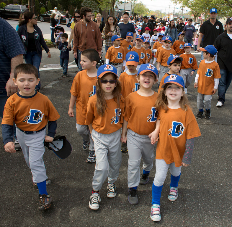 Megan Green, left, Vanessa Puluso and Giuliana Stephos led Franklin Square Little League members along Hempstead Turnpike in Franklin Square on Saturday, during the league’s annual Opening Day parade. A ceremony was held at Rath Park afterward.