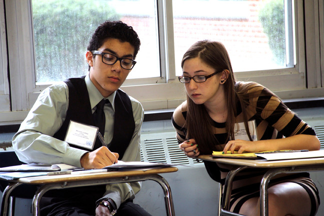 Chinese delegates Michael Lopez and Haley Spielberg took notes during the SIDMUN competition's Security Council meeting.
