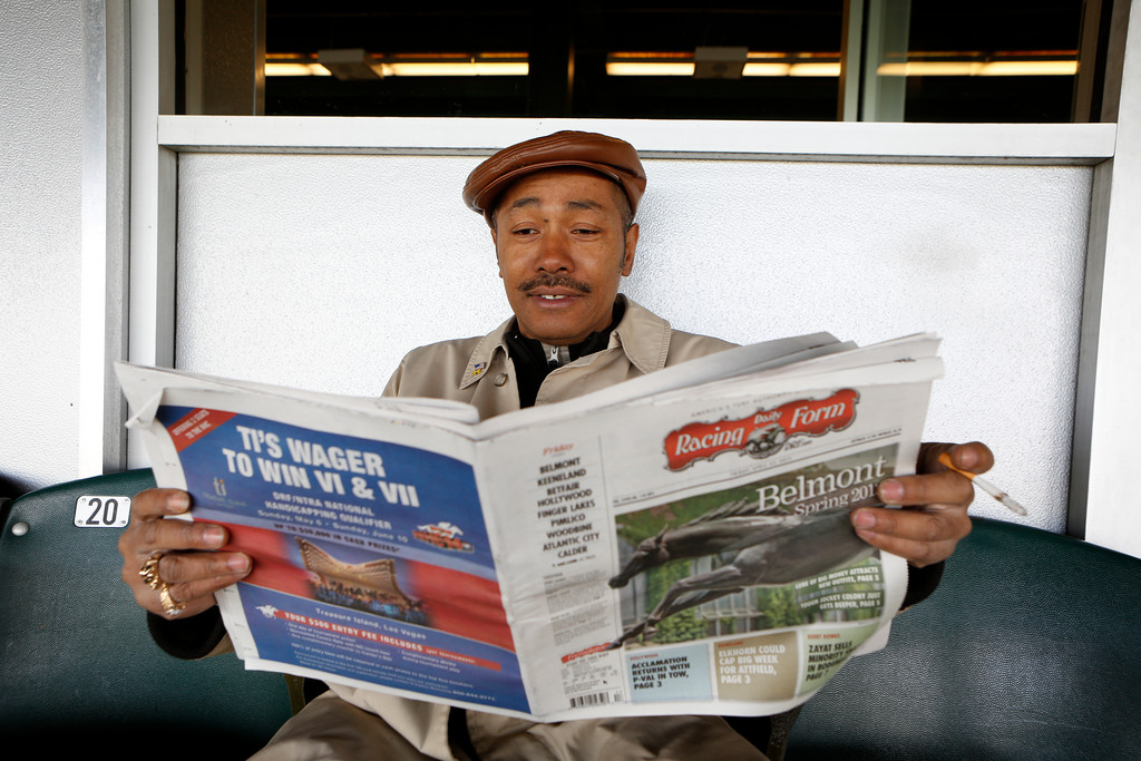 Marshall Warren read The Daily Racing Form prior to the first race on Belmont’s Opening Day last week.
