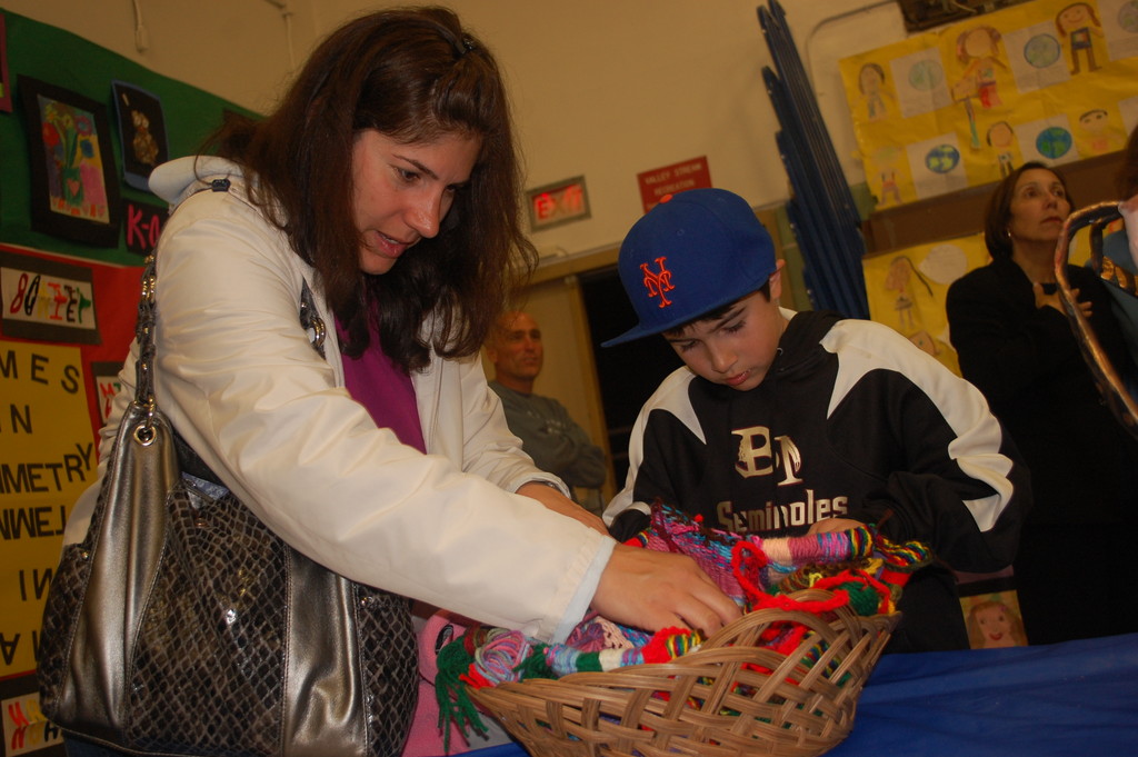Antonio Buccellato, a fourth-grader at Willow Road School in Franklin Square, looked over a weaving project with his mother, Nicole, during the Lights on for Education Program last Thursday evening at Valley Stream Memorial Junior High School. Antonio will get to do the project next year as a fifth-grader.