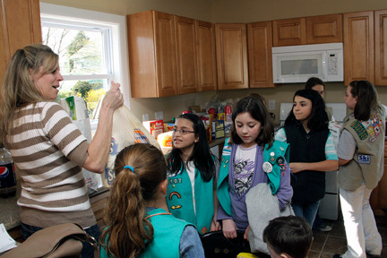 Lynn Clarkin was all smiles on March 30, when nearly a dozen members of the West Hempstead/Franklin Square Girl Scout Association arrived at her husband’s family’s new home in Mineola to deliver housewarming gifts.
