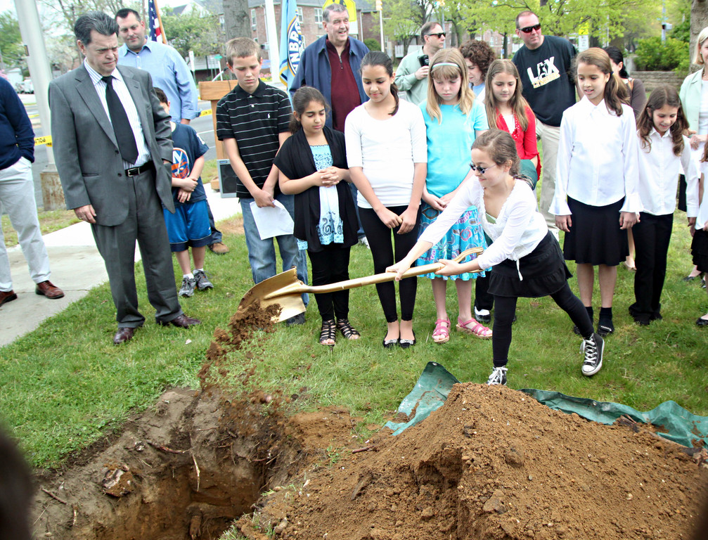 West End student Jolie Sebel shoveled some dirt back into the hole to cover the time capsule.