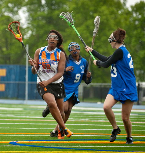 Malverne/East Rockaway's Halle Johnson, left, avoids a pair of Valley Stream defenders during the season finale for both teams May 8. The Lady Rockin' Mules enjoyed their share of success this spring. Story, additional photo, page X.