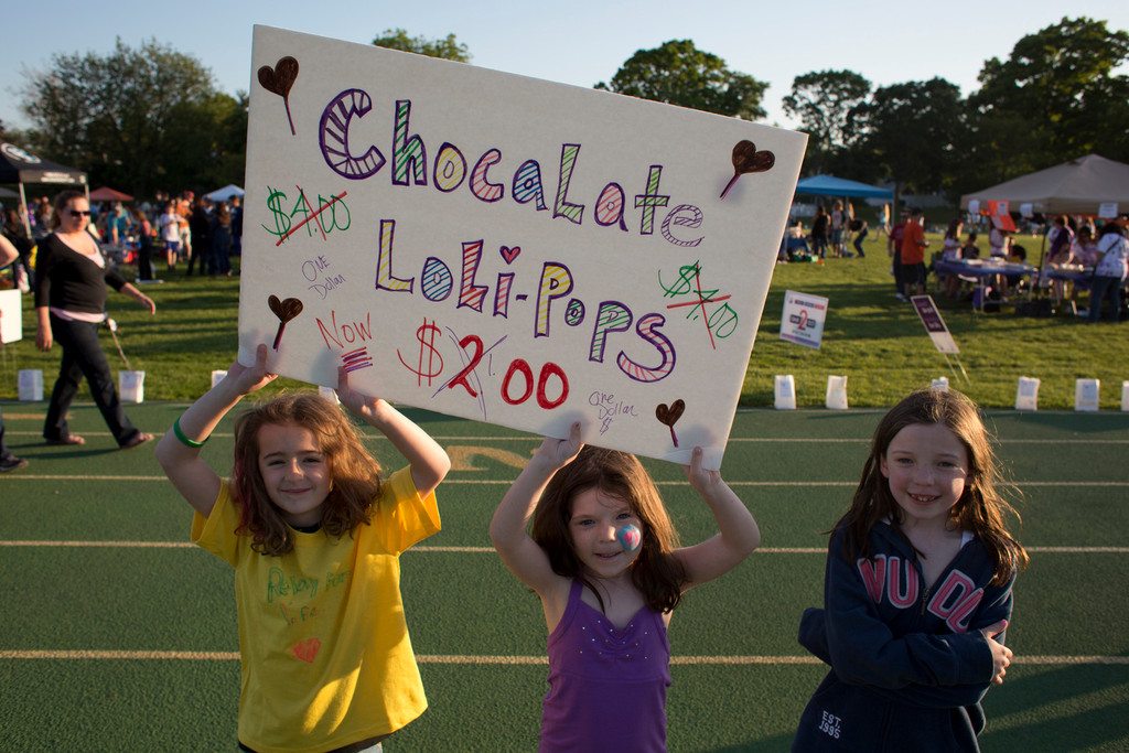 May Doolig, left, Kelly Hayes and Kate Doolig sold chocolate lollipops during the walk.