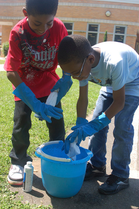First-graders Jared Green, left, and Andy Dorant tie-dye their T-shirts.