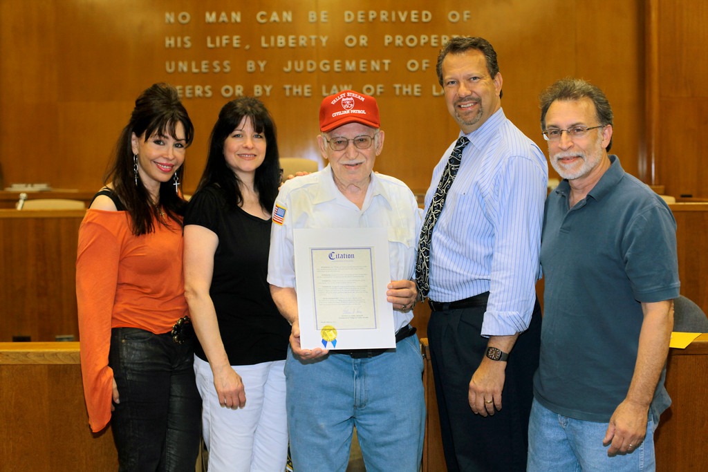 Civilian Patrol member Frank DiCarlo, center, was able to share the moment with his family when he received a citation from Valley Stream Mayor Ed Fare.