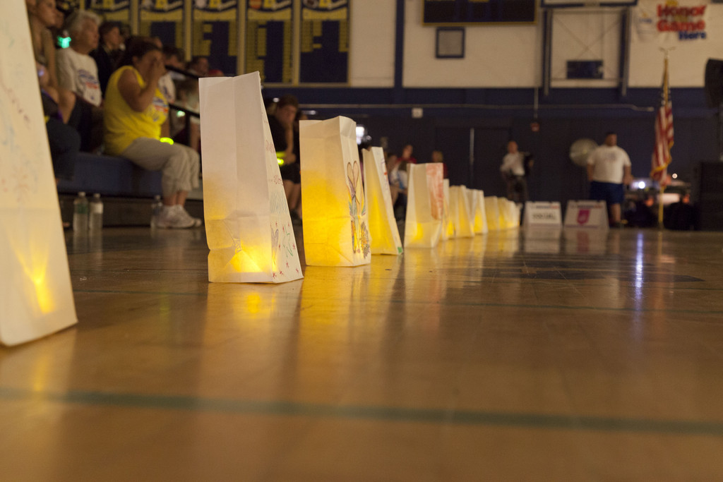 Candles in paper bags created a sombre mood in the gymnasium while participants walked.