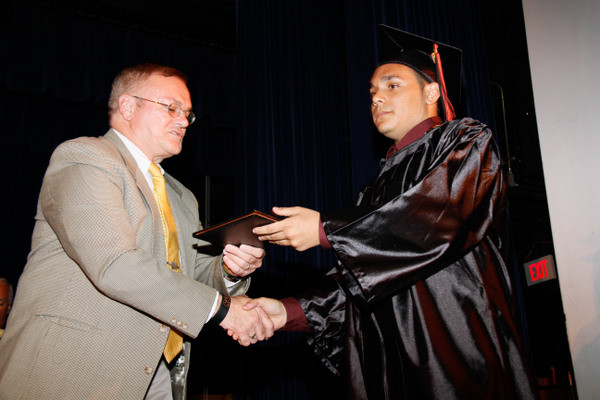 Matthew Bellaflores received his diploma from School Board President Neil Schloth