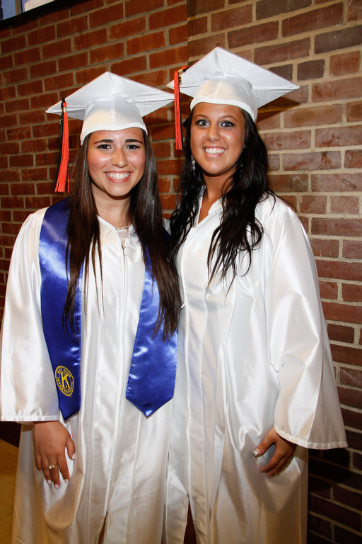 Michella Riggio and Kaitlin Robinson in the hallway before they walked into the auditorium for their graduation ceremony.