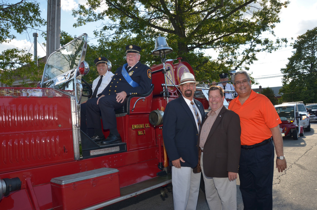 Town of Hemsptead Senior Councilman Anthony J. Santino was joined by East Rockaway Mayor Fran Lenahan and East Rockaway Trustee Ed Corrado at the stepping-off point of the parade to express deep appreciation and thanks to Fred Weiss for his 57 years of dedicated service to the community as a member of the East Rockaway Fire Department. Pictured (on 1927 Fox Fire truck from left Tony Badolato of the Lynbrook Fire Department and Honorary Chief Fred Weiss of the East Rockaway Fire Department; standing from left were East Rockaway Mayor Fran Lenahan, East Rockaway Trustee Ed Corrado and Senior Councilman Anthony J. Santino.