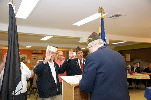 Commander Joe McCarthy is sworn in by Harry Wurth