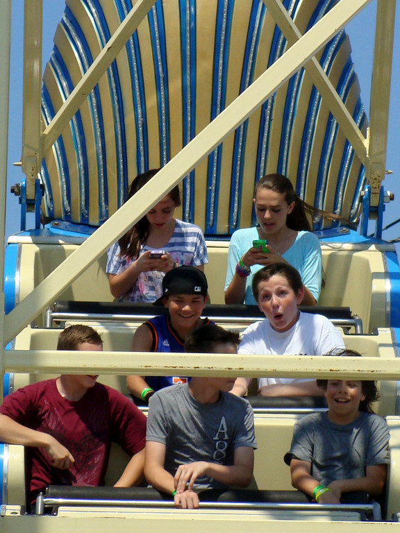 Two fearless teens took time out during a ride on the Pharoh’s Fury to check their phones.