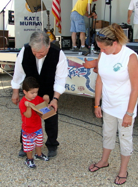 Magician Mark Warner, of East Meadow, performed a magic card trick with audience members Anthony Miranda, 3 and Dawn Maloney of the East Rockaway Recreation Department.