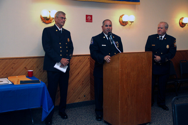 East Rockaway Fire Department Chief Steve Torborg, center, had good words to say about the honorees John Van Houten, left, and Pete Dixon, right.