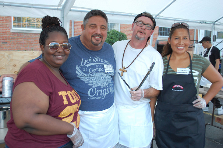 Parishoners, from left, Vivian Mukuka, Joe Andreo, Richie Wendt and Ana Alvarez were among the 200 plus volunteers who worked at the fair last weekend.