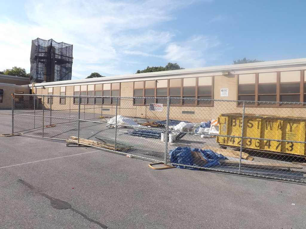Construction on the William L. Buck School in District 24 includes rebuilding the structure of the chimney and realigning some of the exterior bricks.