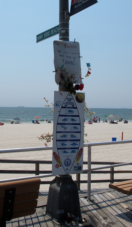 A lightpost honors Danny Bobis, above. A bench inscription, below.