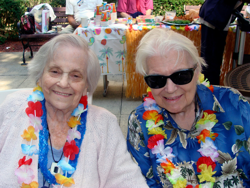 Friends Goldie Chaplick, left, and Arvilla Johanssen wore colorful leis and enjoyed the music, the food and the entertainment.