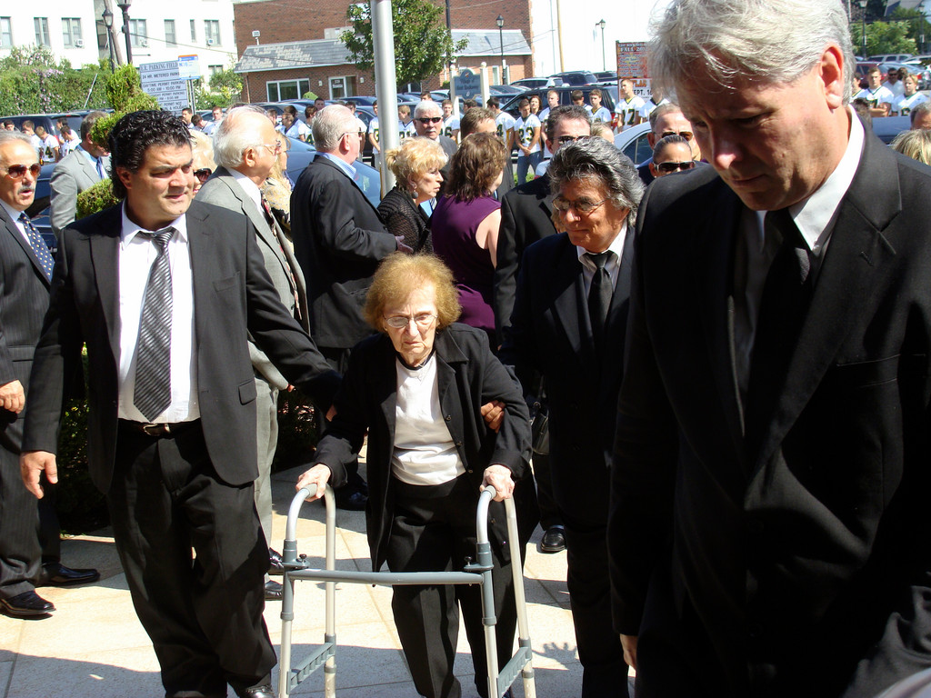 Barbarino’s mother, Santa, arrived at the church escorted by her son, Al, right, and family friends.
