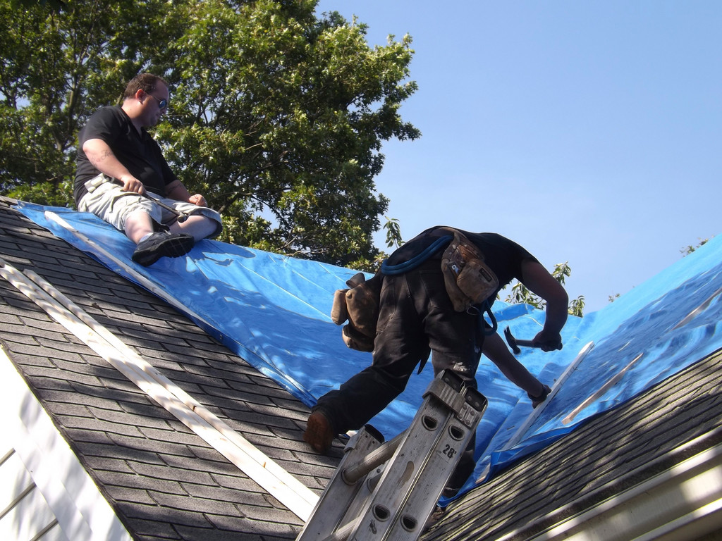 Contractors from Lanzello Roofing and Remodeling covered the roof of one of the damaged homes with a tarp late last week.