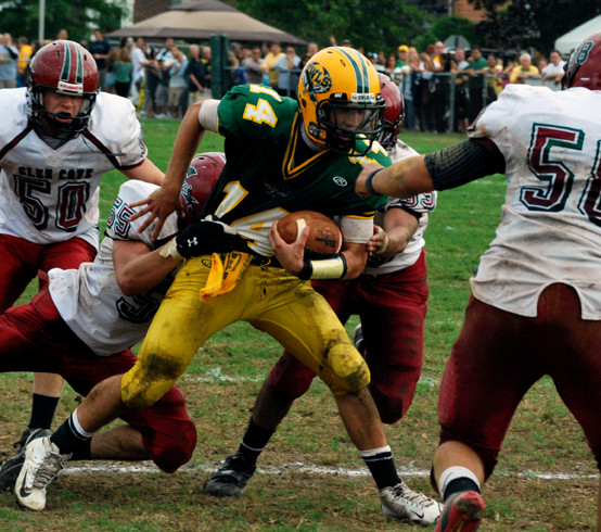 Lynbrook quarterback Eduardo Martinez fended off a swarm of Glen Cove defenders late in last Saturday's Conference III game.