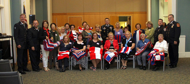 Stitches from the heart members, along with members of the Lynbrook amd Floral fire departments and the military, gathered for a photo at the event. They are pictured with some beautiful lap robes that they made