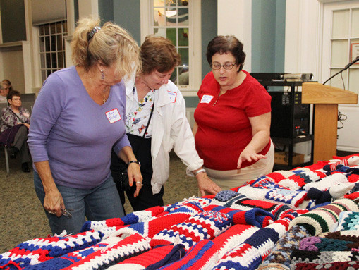 Amy Holler, Geraldine Coney and Roberta Lutz admired the workmanship of the blankets.
