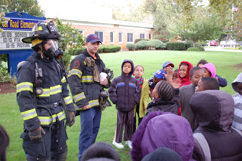 Valley Stream Firefighters Tom McBride, left, and Ryan Mastrangelo showed students at the Forest Road School what their gear looks like.