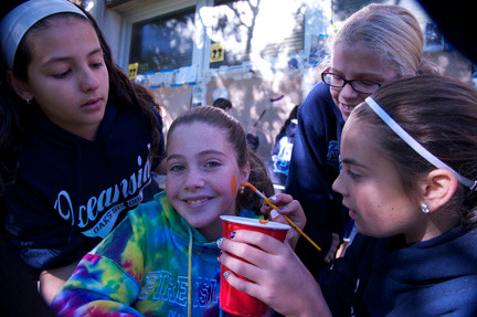 Sabrina Foster, left, Olivia Burnside, second from right, and Lucia Alamia practiced their skills on Casandra Dolan.