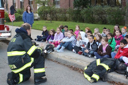 At a Safety Week presentation at Lynbrook’s West End School, Lynbrook Fire Department Capt. Peter Festa reminded second-graders to “stay low and go.”