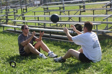 Craig Yanantuono and fellow firefighter Keith Eckels played a heavy game of catch to work their arms and abs.