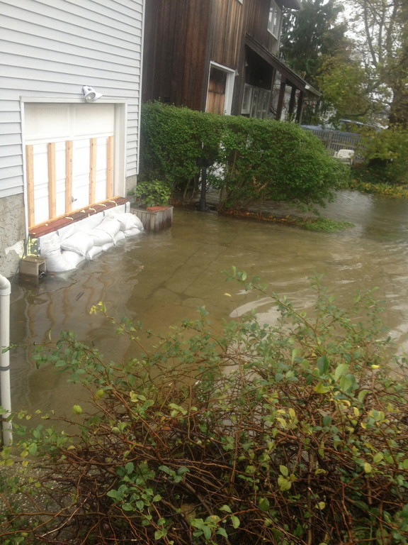 Boyd Street resident Roy Lester constructed a concrete barrier and placed sandbags in front of his home, but said that the flooding is still too much.