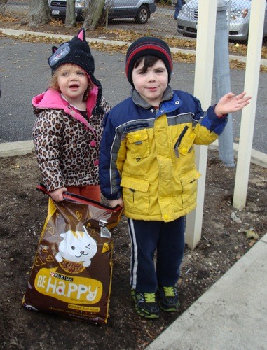 Siblings Giavanna and Joshua Cervone picked up a bag of food for their cat.