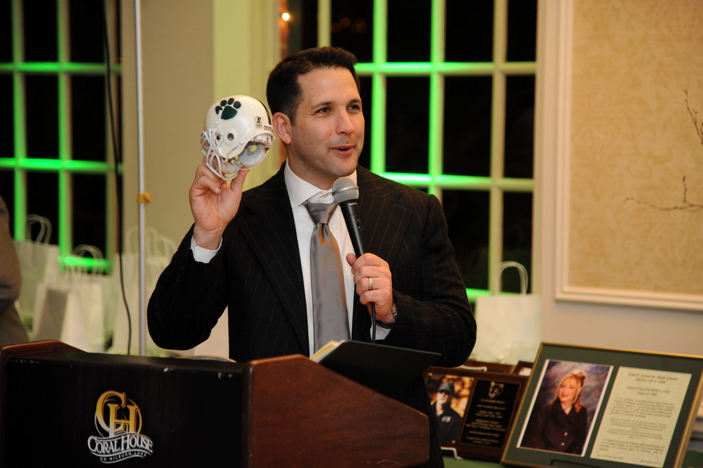 Adam Schefter, National Football League sports analyst, was presented with a mini cougar helmet to be placed on his bookcase during ESPN broadcasts.