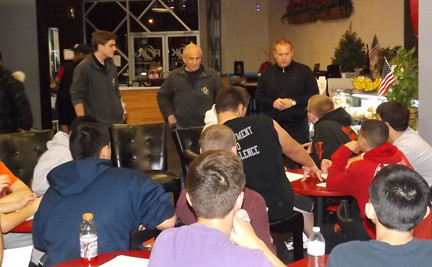 ROK’s co-owners, Mike Hawksby, right, and Bob D’Urso, center, addressed ERHS athletes on Dec. 7 with Craig D’Urso, the executive director of operations, before treating the students to pizza.