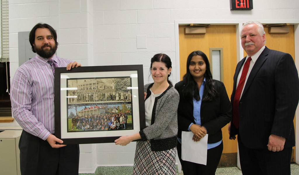 Art Teacher Mario Bakolov presented the picture to Board of Education Vice President Elise Antonelli on Dec. 11. They were joined by Central senior Rida Javaid and Principal Dr. Joseph Pompilio.