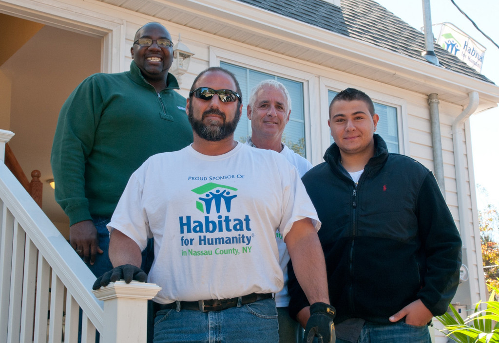 Standing on the finished house’s porch were, in back, from left, Barry Tech Principal James Clark, Nassau County Habitat for Humanity Vice President Tom Baccarelli, Nassau BOCES Vice District Clerk Michael Weinick, and Lynbrook High School and Barry Tech student Giuseppe Condeleo.