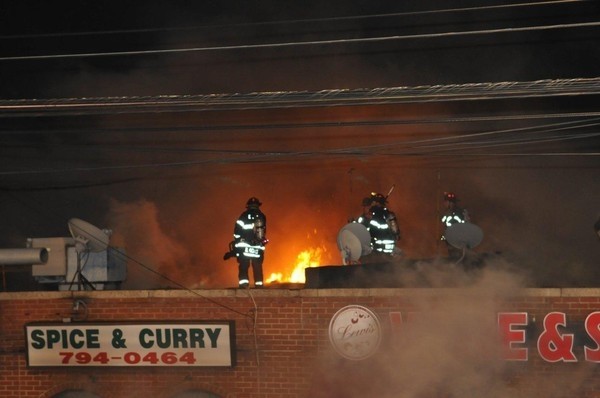 EMFD volunteers fought the flames from the rooftop of the Spice and Curry Halal Meat store.