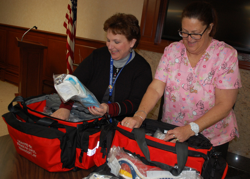 School nurses Estelle Dempsey and Cathy Hicks looked at all the items provided in the kits.