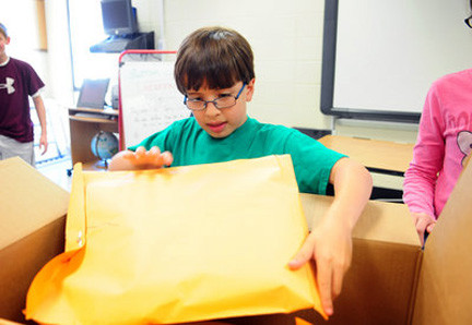 Third-grader Eli Medof approached approached Tritt’s principal and student council for their support. In photo, Eli helps box up cards and letters written for the East Rockaway school district.