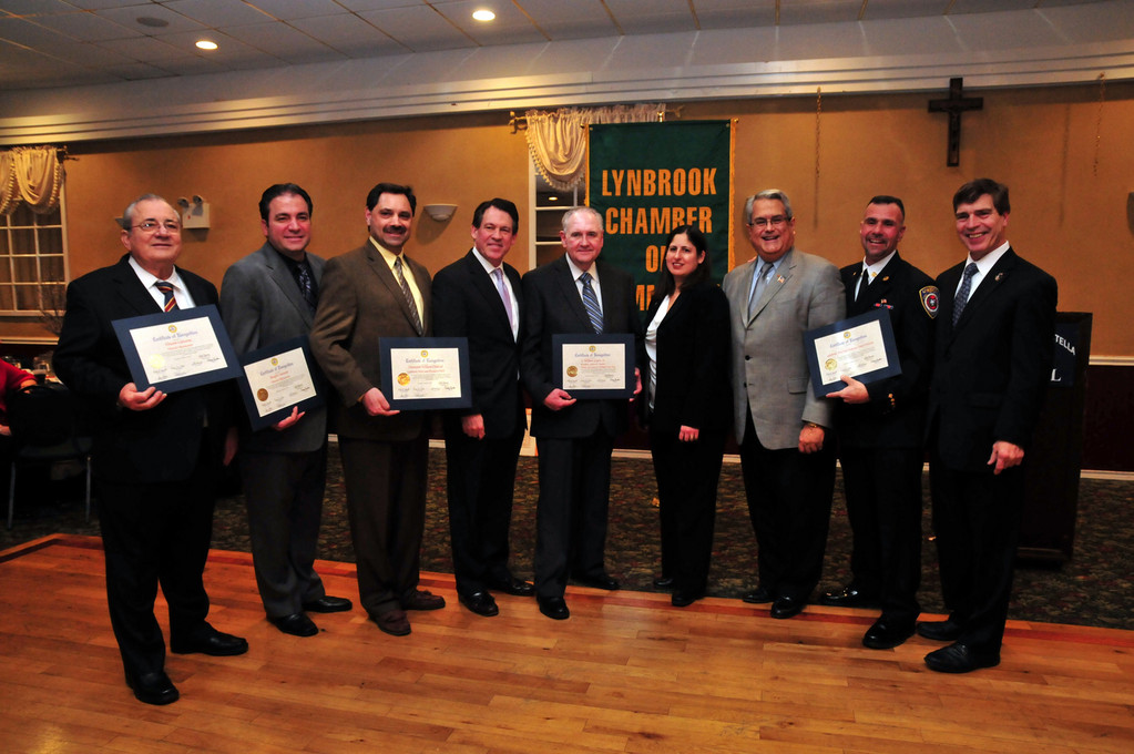 The Honorees accepted their awards from the Lynbrook Chamber. Pictured from left were honorees Vincent and Joseph Carusone, Sgt. Joseph Cipolla, accepting for awardee Det. William Diebold, who was unable to attend; Leg. Francis X. Becker, Honoree and outgoing Chamber president William Gaylor; new Chamber president Denise Rogers, Town of Hempstead Councilman Anthony Santino, honoree Chief Anthony “Zemo” DeCarlo, and Lynbrook’s Deputy Mayor Alan Beach.