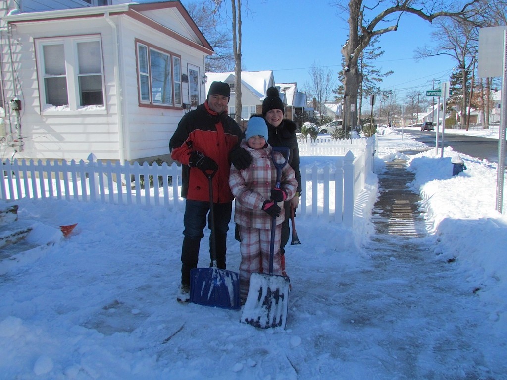 The Montanari family of East Mineola Avenue takes a break from shoveling.