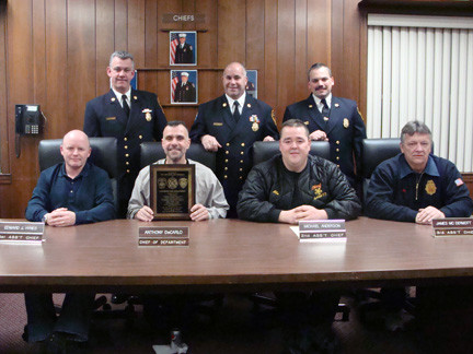 Lynbrook fire chiefs accepted a heartfelt thank you from the East Rockaway Fire Department. Pictured seated were, from left, 1st Assistant Chief Ed Hynes, Chief of Department Anthony DeCarlo, 2nd Assistand Chief Michael Anderson, and  3rd Assistant Chief James McDermott. Standing were East Rockaway Fire Department chiefs, from left, 2nd Assistant Chief James Henshaw, Chief of Department Steve Torborg, and 3rd Assistant Chief Tom Johnson.