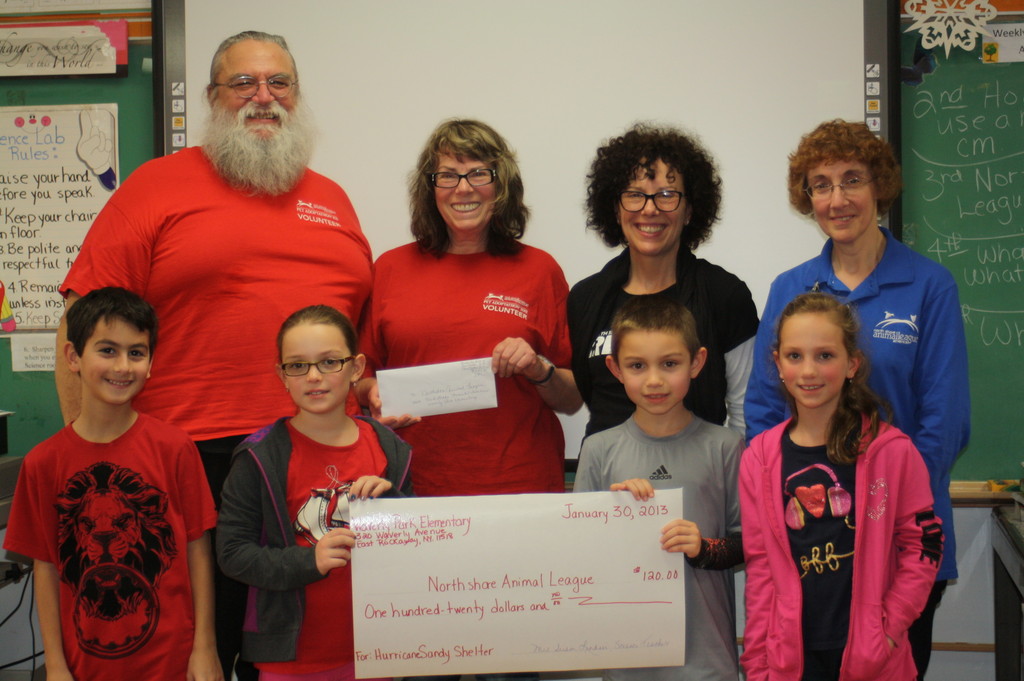 The third-graders presented a check for $120 to representatives from NSALA to show their support of the hurricane relief shelter. In front were Waverly Park students Jordan Abate,left, Katherine Tuosto, Aidan Blank and Natalie Tuosto. In rear were NSALA  representatives Ben and Marian Savio, Jayne Vitale and Lauraine Merlini.